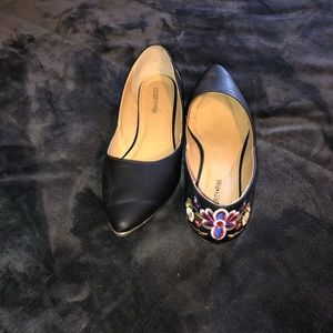 Black flats with gold lining and floral on back